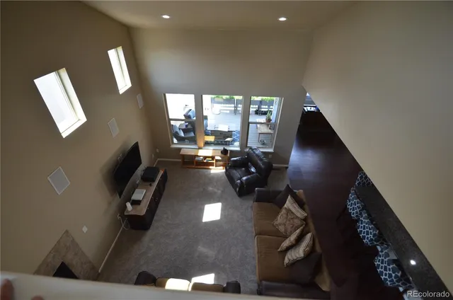 a living room with furniture and a floor to ceiling window