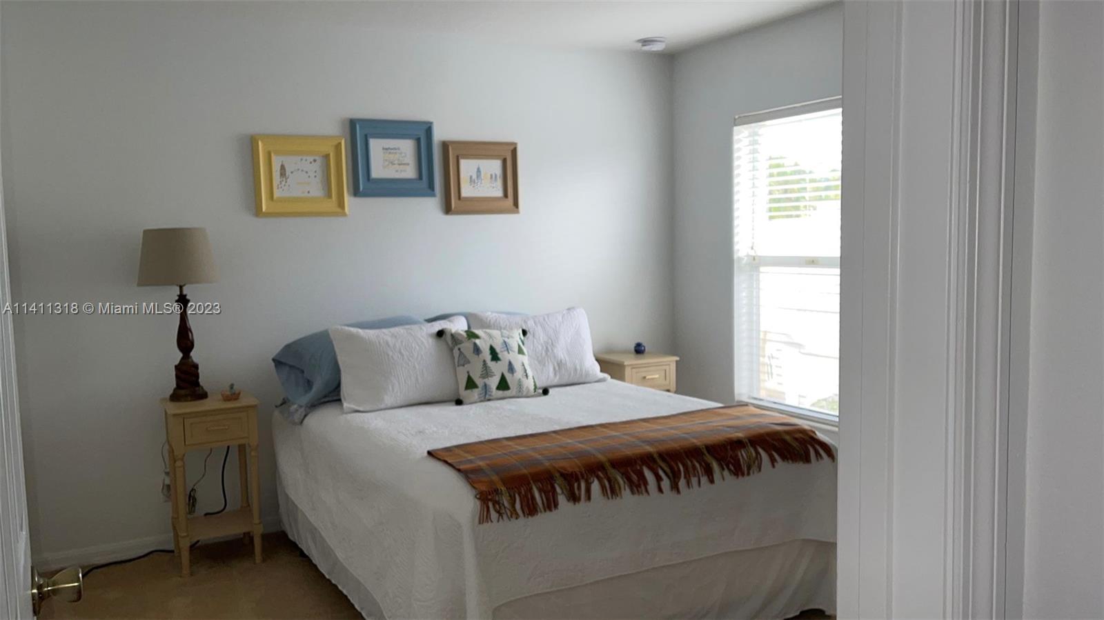 4292 Southwest Paley Road Port St. Lucie, FL 34953 - Photo 15 of 21 a bedroom with a bed and a window