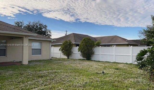 4292 Southwest Paley Road Port St. Lucie, FL 34953 - Photo 19 of 21 a view of a house with a yard and garage