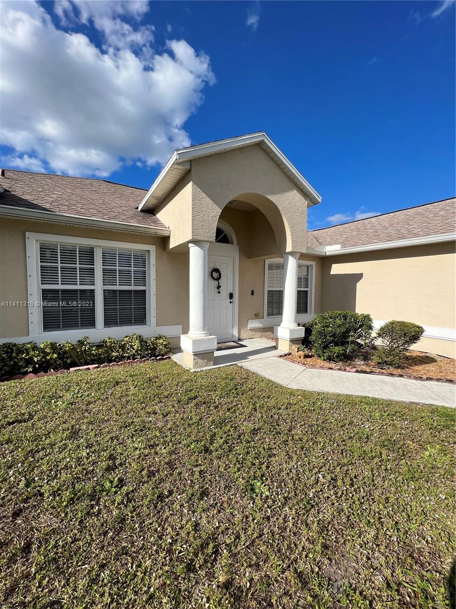 4292 Southwest Paley Road Port St. Lucie, FL 34953 - Photo 2 of 21 a front view of a house with garden