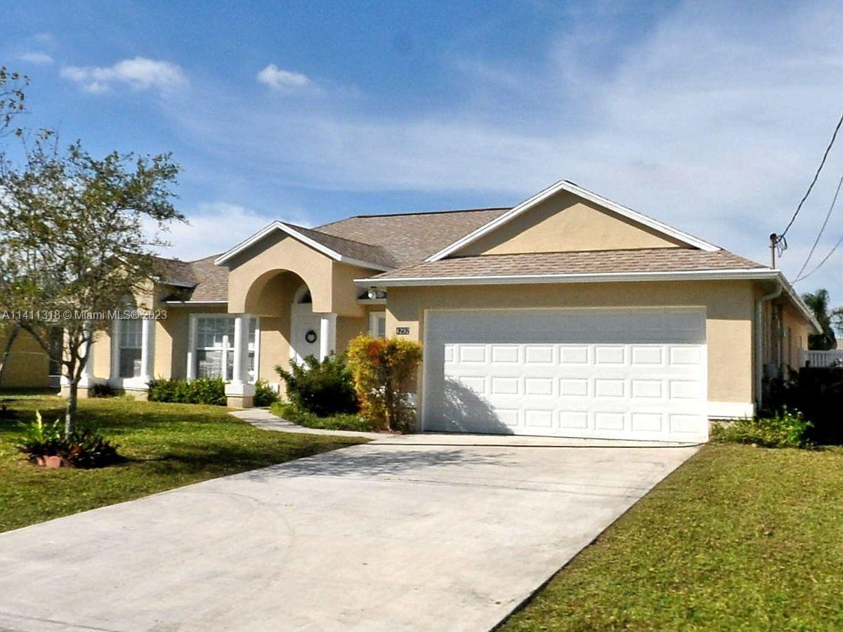 4292 Southwest Paley Road Port St. Lucie, FL 34953 - Photo 21 of 21 a front view of a house with a yard