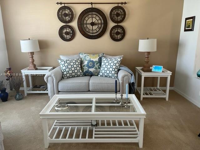 4292 Southwest Paley Road Port St. Lucie, FL 34953 - Photo 5 of 21 a living room with a clock and a table