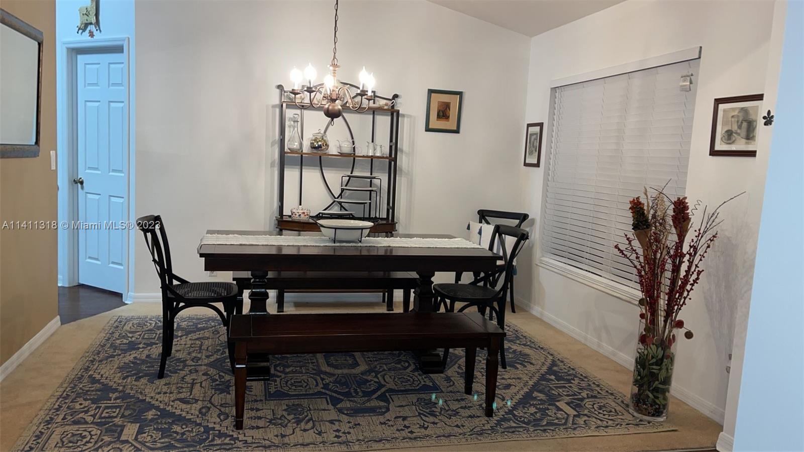 4292 Southwest Paley Road Port St. Lucie, FL 34953 - Photo 6 of 21 a view of a dining room with furniture and chandelier