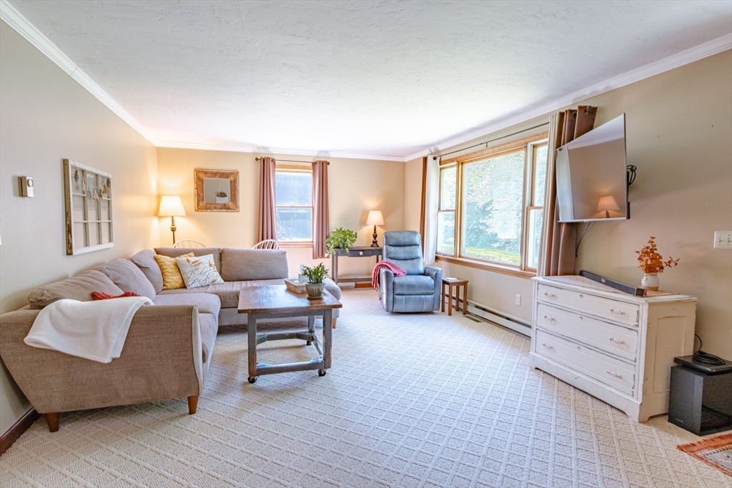 27 Comins Road North Oxford, MA 01537 - Photo 10 of 32 a living room with furniture and a large window
