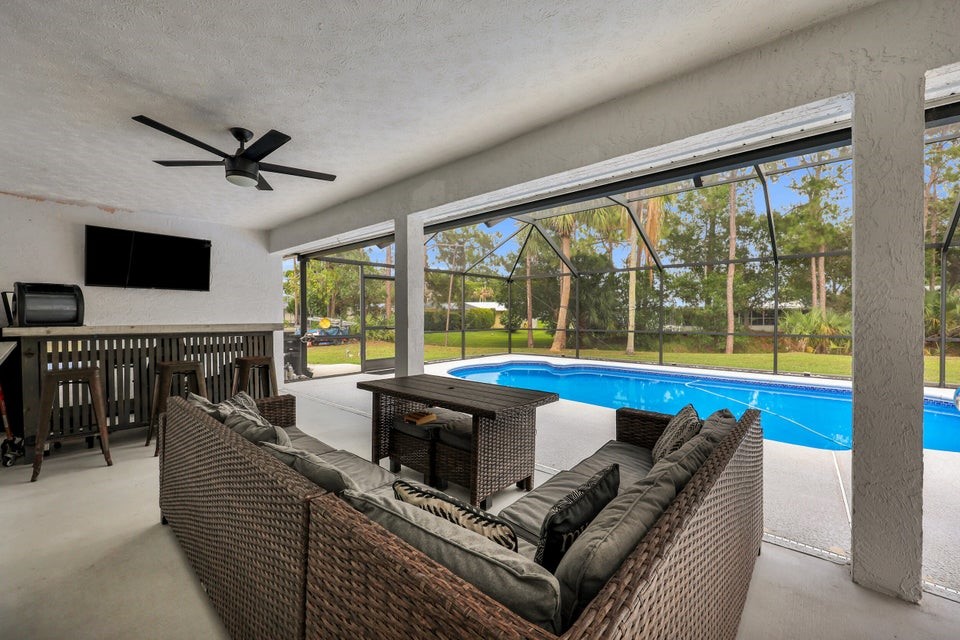 1950 Southwest Logwood Road Port St. Lucie, FL 34953 - Photo 22 of 32 a living room with furniture and a large window