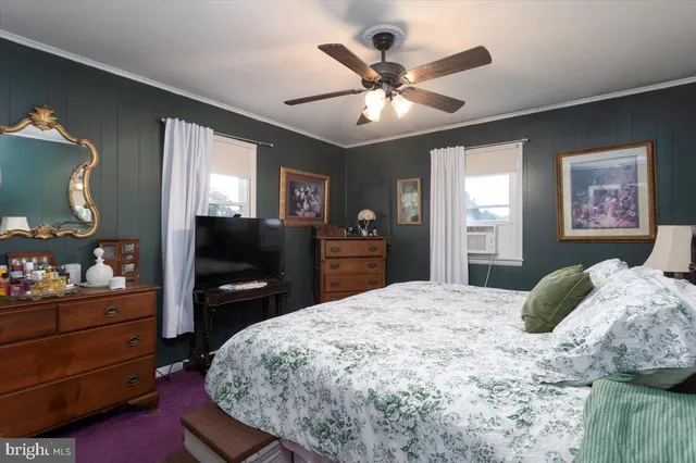 a bedroom with a bed and a dresser in it
