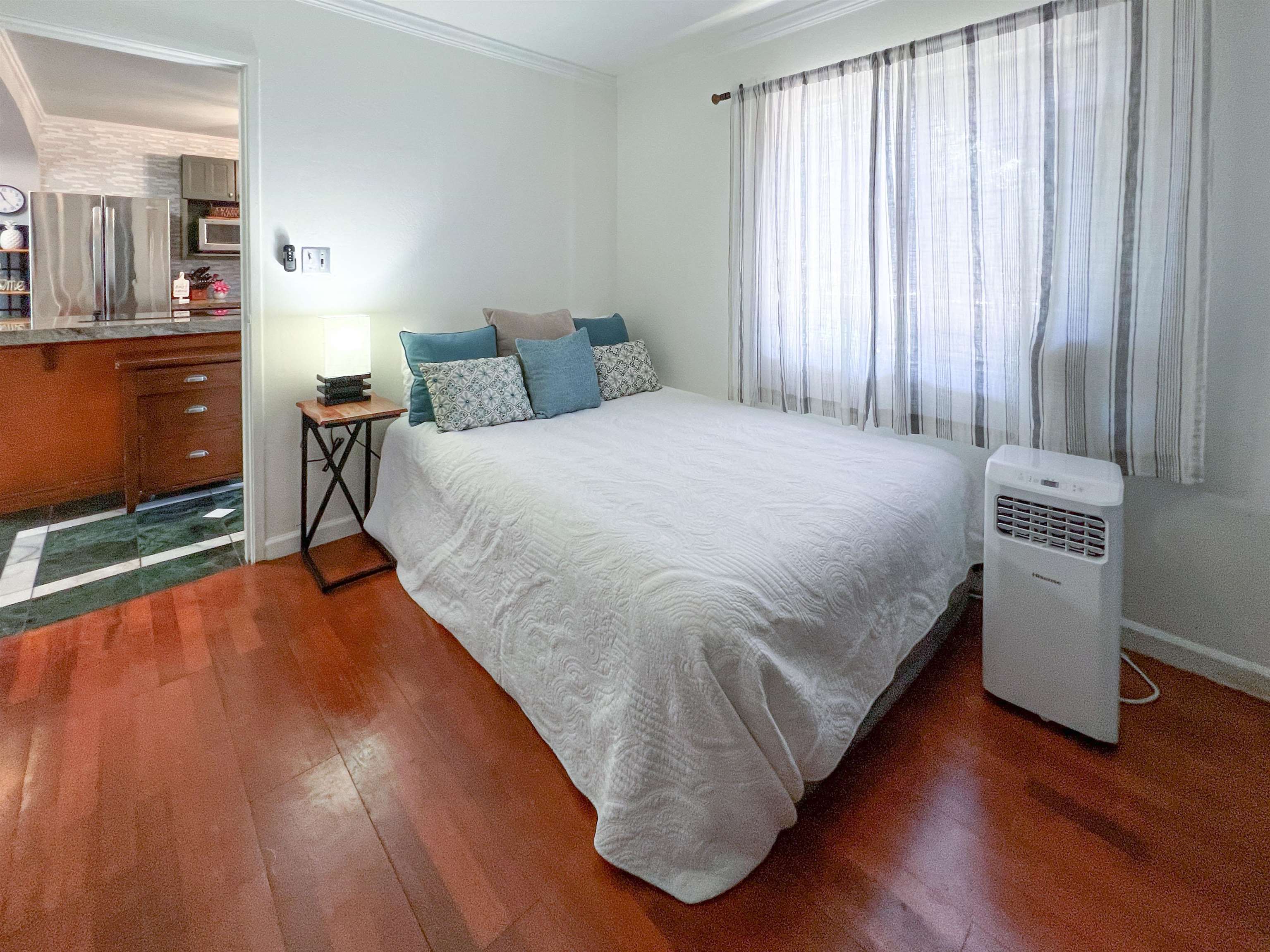2219 South Kihei Road, Unit A314 Kihei, HI 96753 - Photo 12 of 20 a bed sitting in a bedroom next to a window