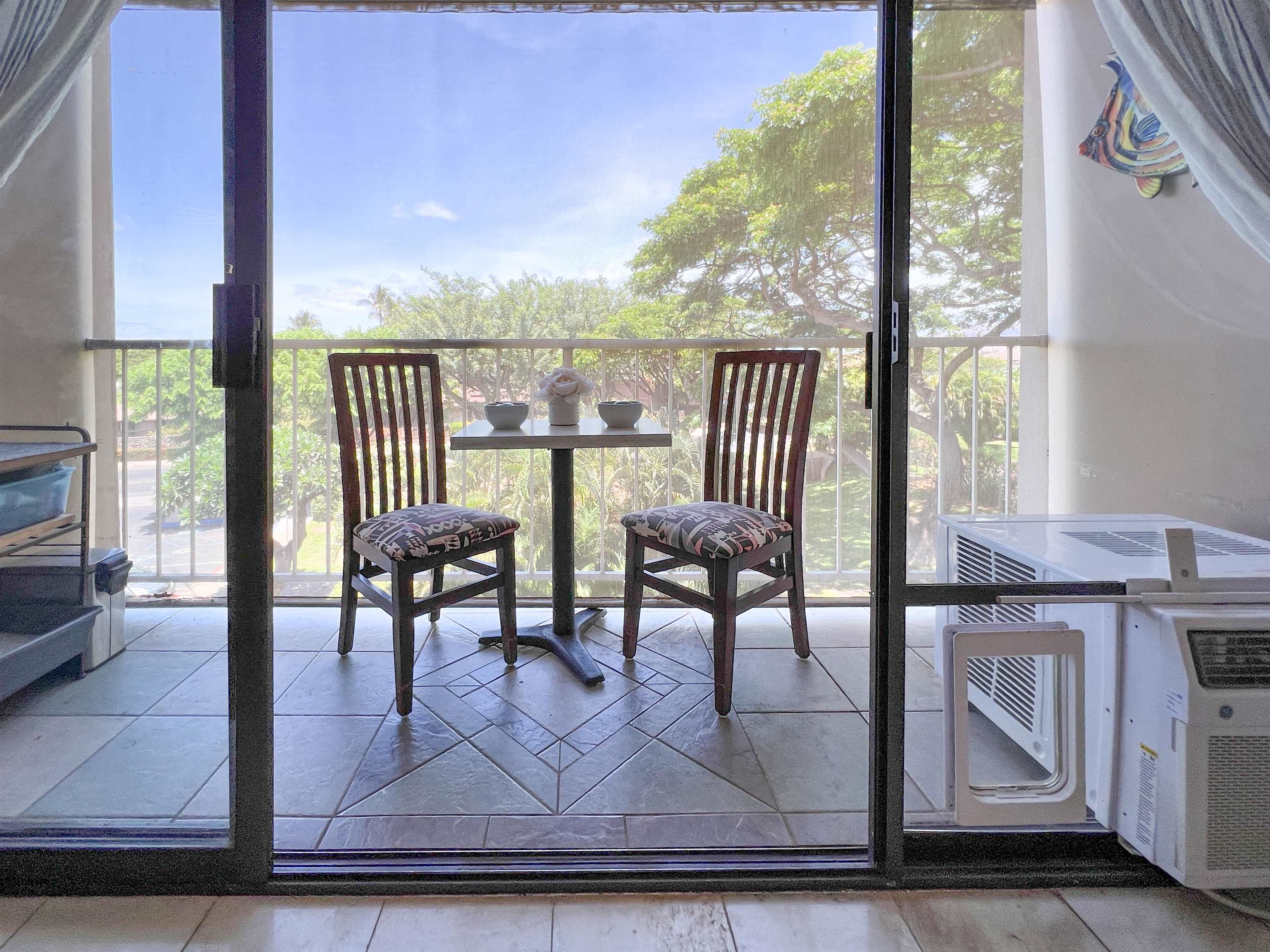 2219 South Kihei Road, Unit A314 Kihei, HI 96753 - Photo 6 of 20 a view of a dining room with furniture window and wooden floor
