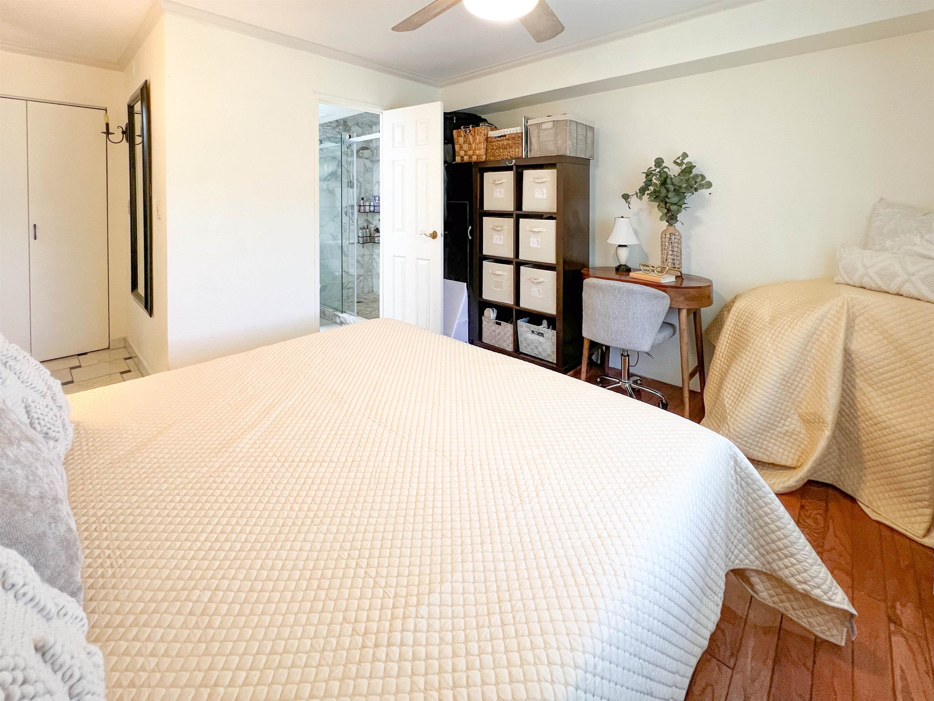 2219 South Kihei Road, Unit A314 Kihei, HI 96753 - Photo 9 of 20 a large bed sitting in a bedroom next to a bookshelf