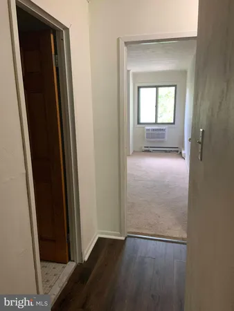 an empty room with windows and closet