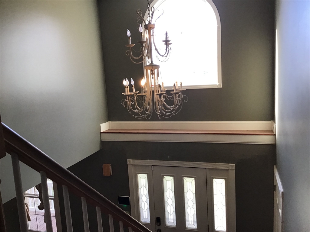 299 Three Rivers Road Wilbraham, MA 01095 - Photo 13 of 32 a view of staircase with railing and a chandelier