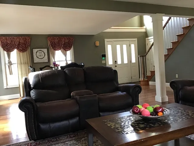 a living room with furniture window and flat screen tv