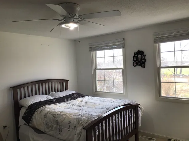 a bedroom with bed and window
