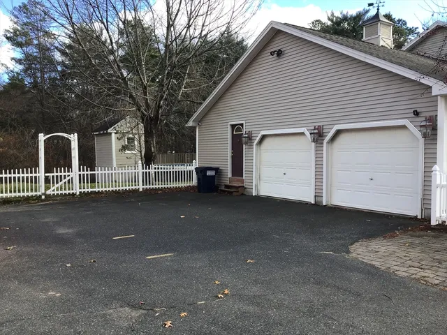 a view of a house with a yard and garage