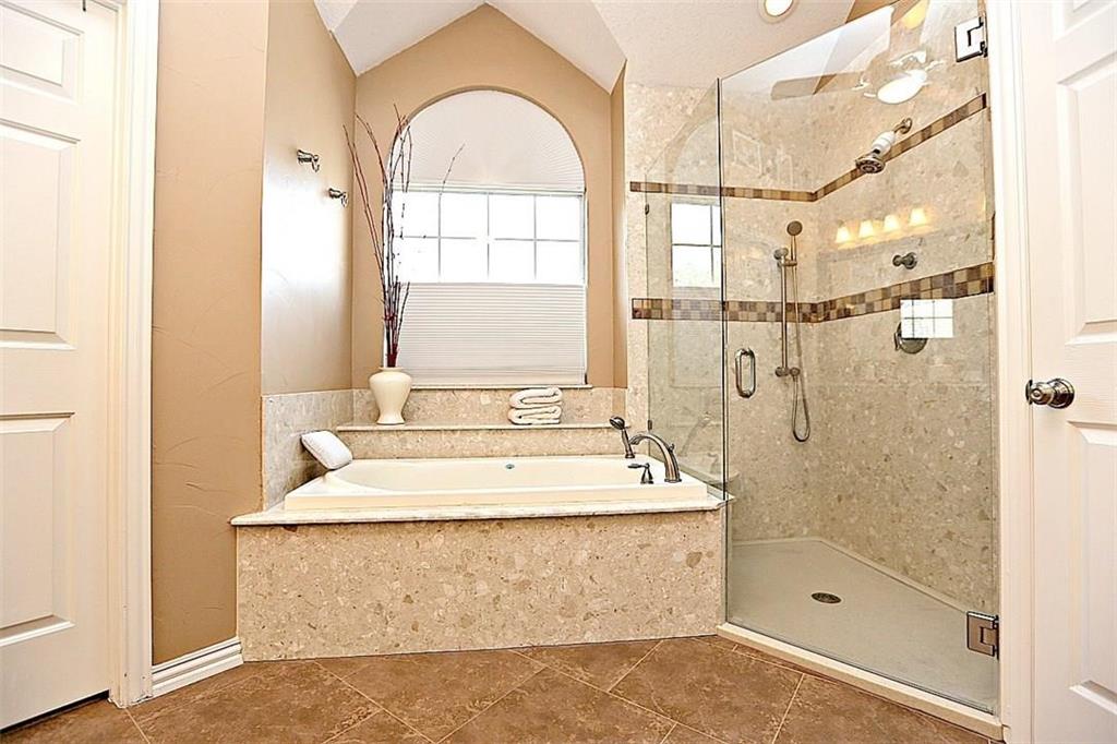 14588 Poe Court Addison, TX 75001 - Photo 20 of 28 a bathroom with a tub a sink and a shower