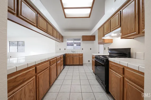 a kitchen with stainless steel appliances granite countertop a stove and a sink