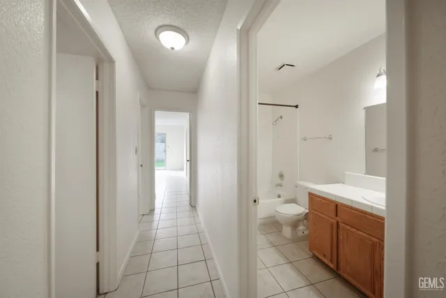 a bathroom with a toilet sink and a mirror