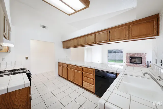 a kitchen with stainless steel appliances granite countertop a sink and cabinets