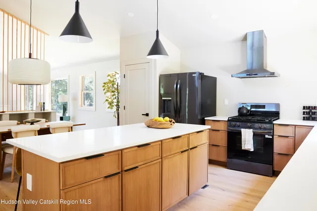 a kitchen with stainless steel appliances a stove a refrigerator and a sink