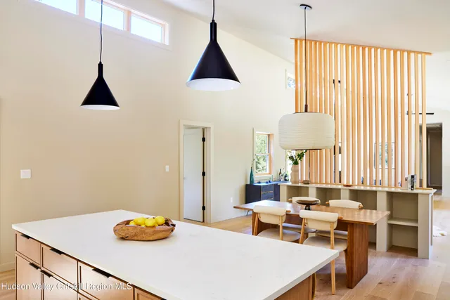 a living room with a table chairs and a table