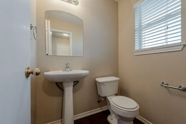 a bathroom with a sink toilet and a mirror