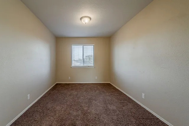 an empty room with a empty space and windows