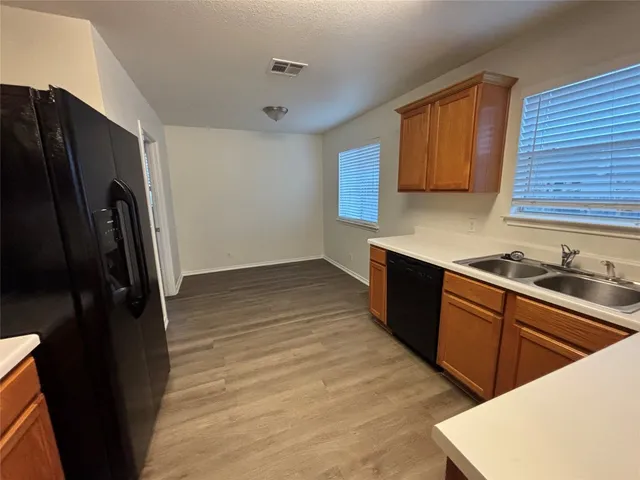 a kitchen with stainless steel appliances a sink stove and refrigerator