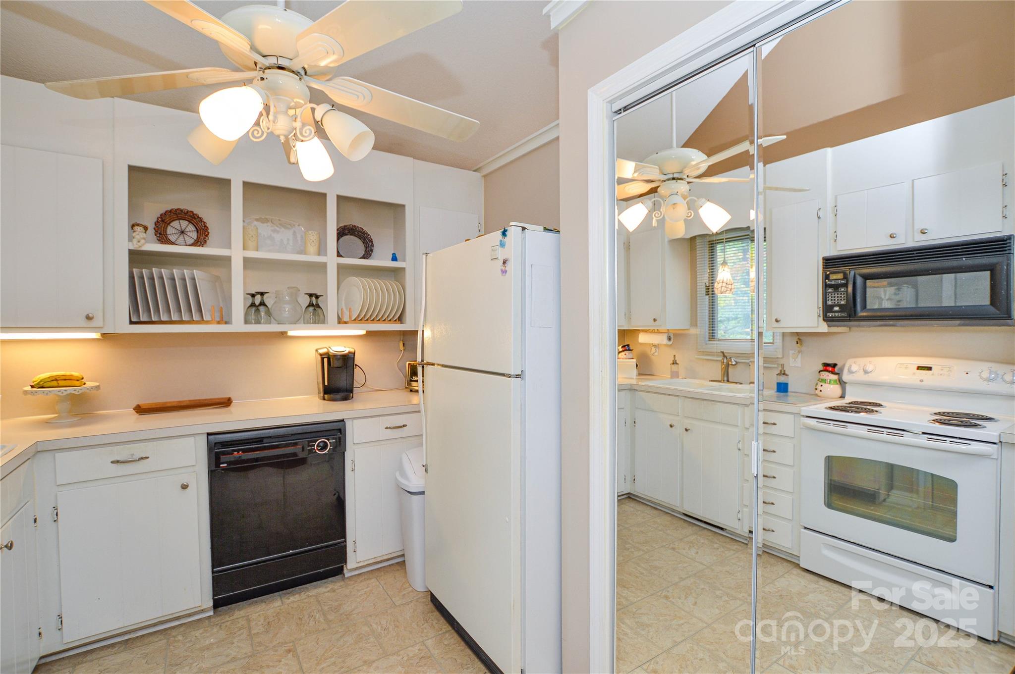 230 Ravine Circle Southeast Concord, NC 28025 - Photo 12 of 25 a kitchen with a sink a stove and refrigerator