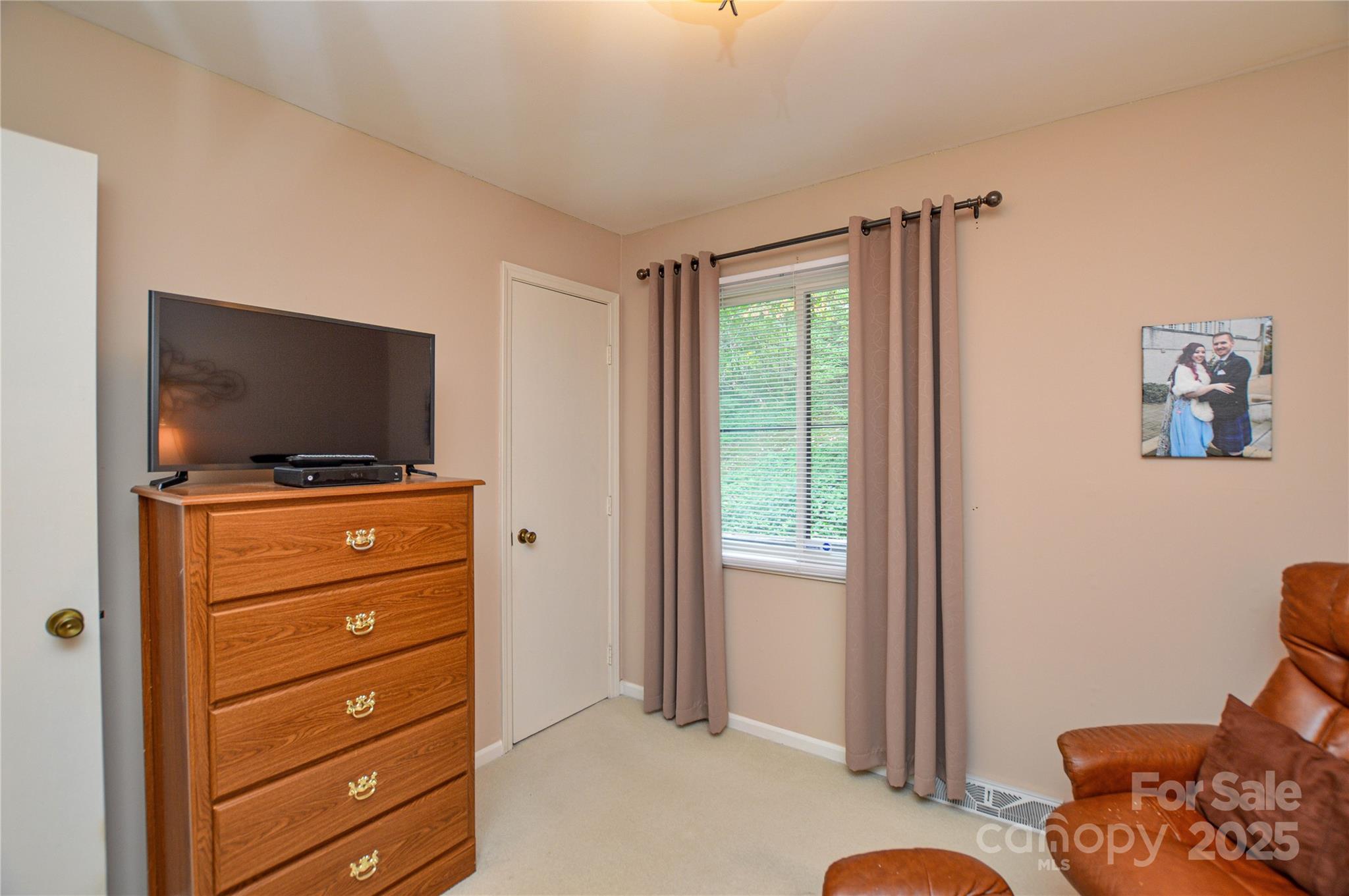 230 Ravine Circle Southeast Concord, NC 28025 - Photo 20 of 25 a living room with furniture and a flat screen tv