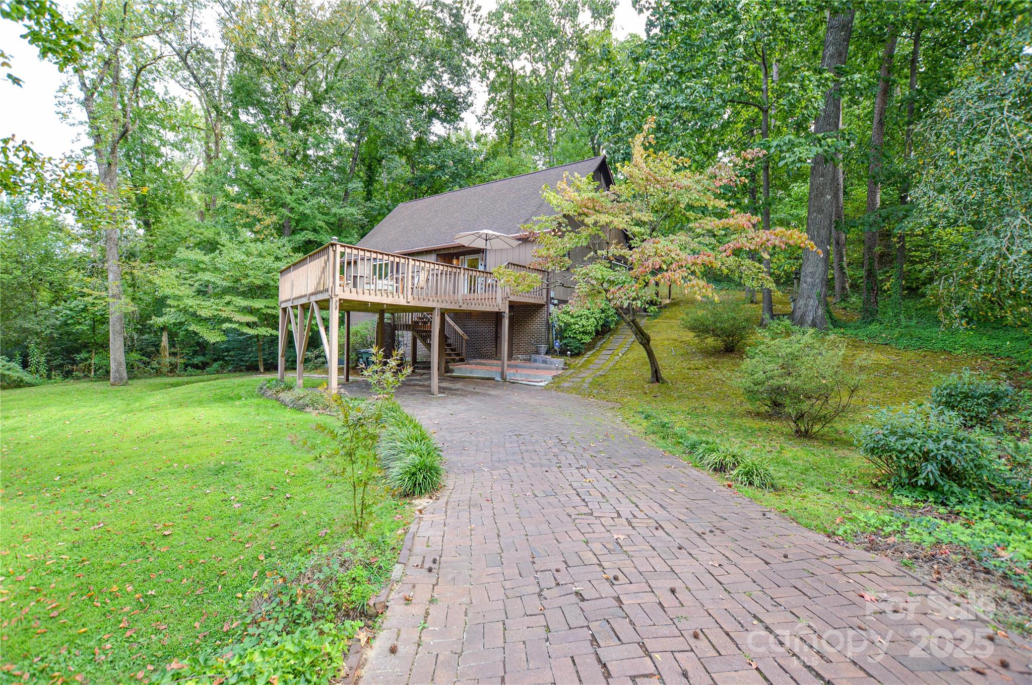 230 Ravine Circle Southeast Concord, NC 28025 - Photo 2 of 25 a view of a patio with table and chairs potted plants and large tree
