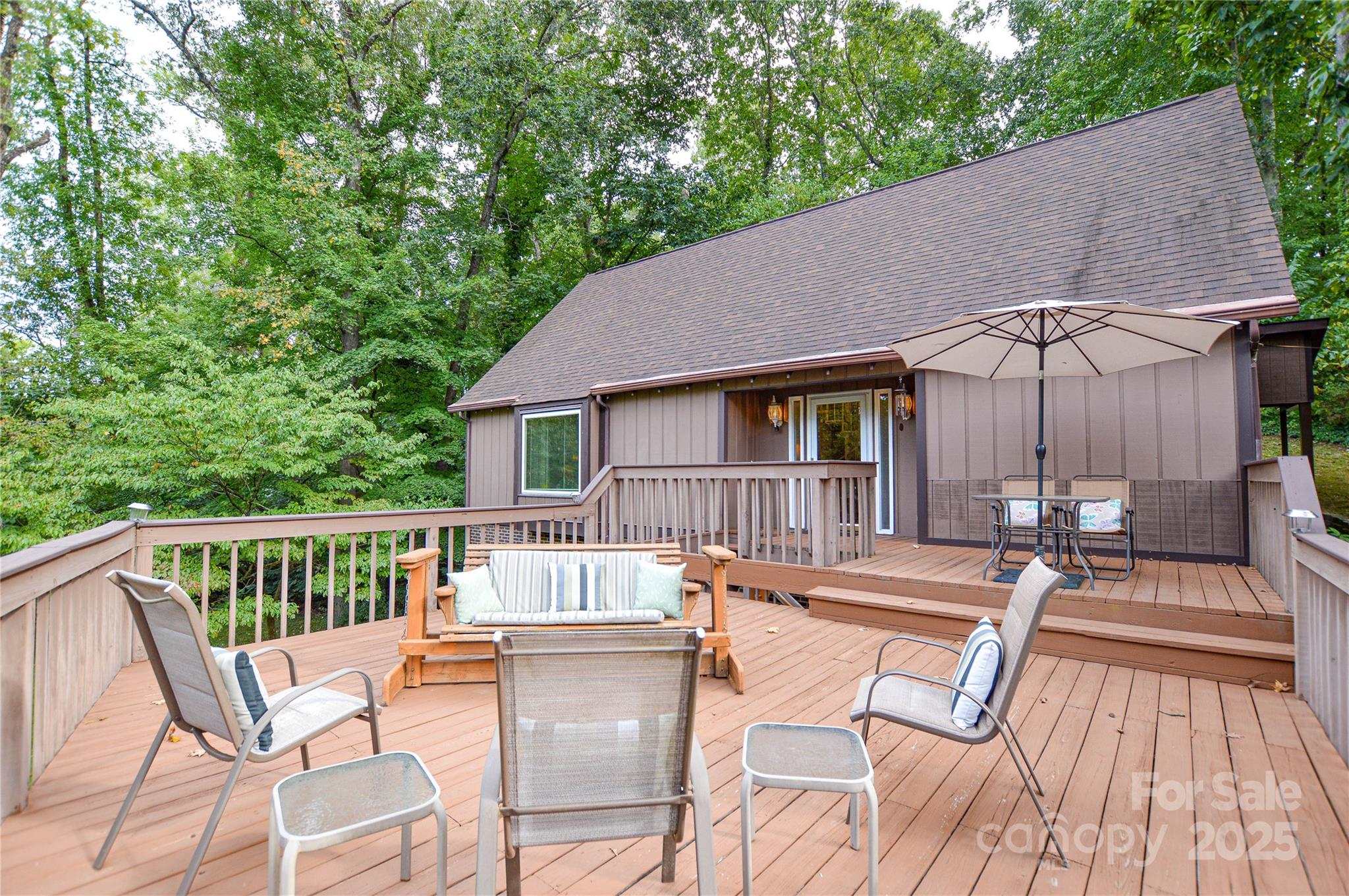 230 Ravine Circle Southeast Concord, NC 28025 - Photo 5 of 25 a view of deck with table and chairs under an umbrella