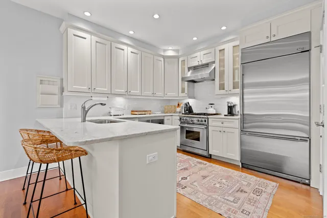 a kitchen with a refrigerator and a stove top oven