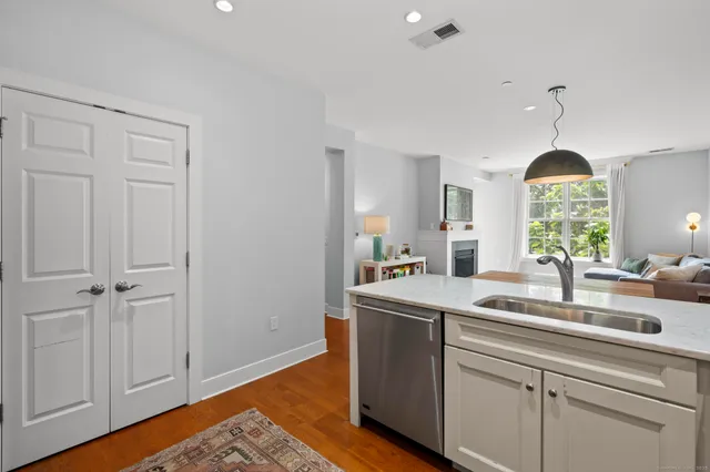a bathroom with a granite countertop sink mirror vanity and toilet