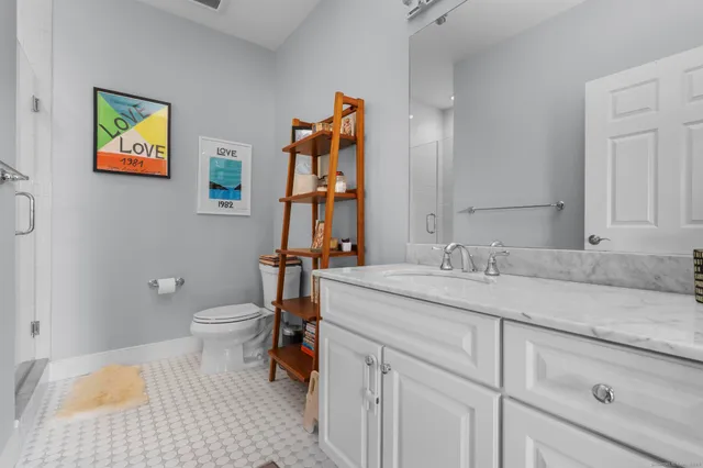 a bedroom with a bed and a flat tv screen next to a window