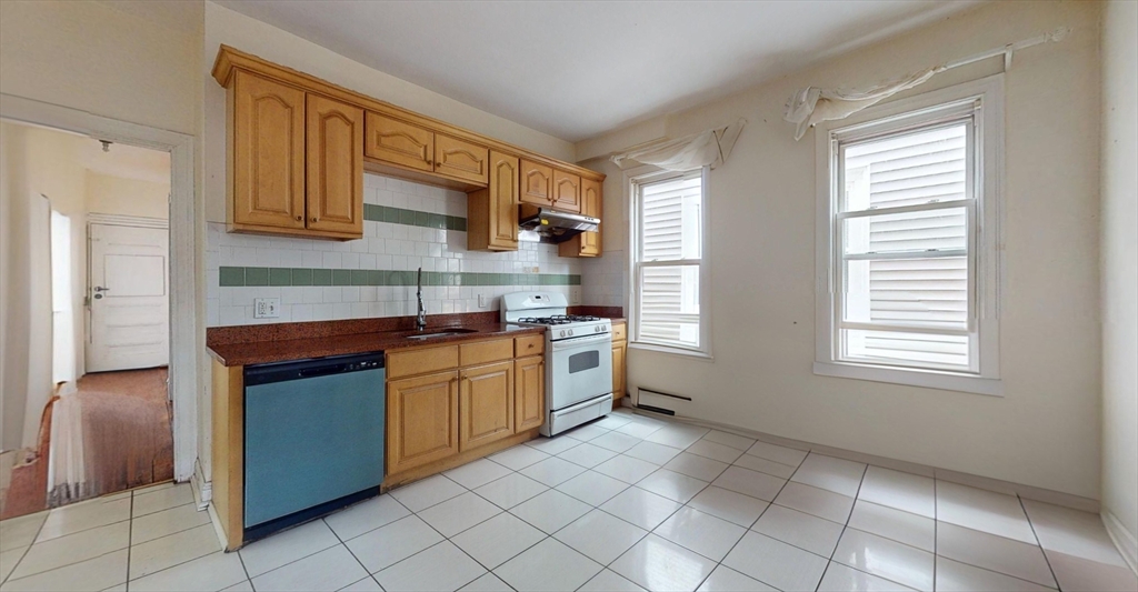 19 Newport Street, Unit 2 Boston, MA 02125 - Photo 1 of 13 a kitchen with stainless steel appliances granite countertop a sink and cabinets