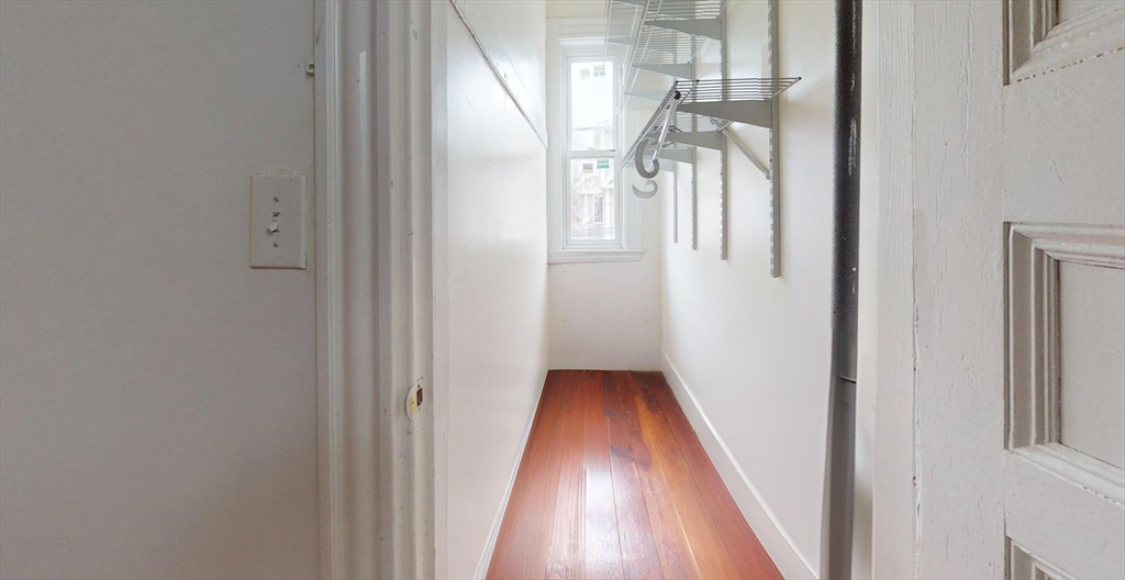 19 Newport Street, Unit 2 Boston, MA 02125 - Photo 11 of 13 a view of a hallway with wooden floor and staircase