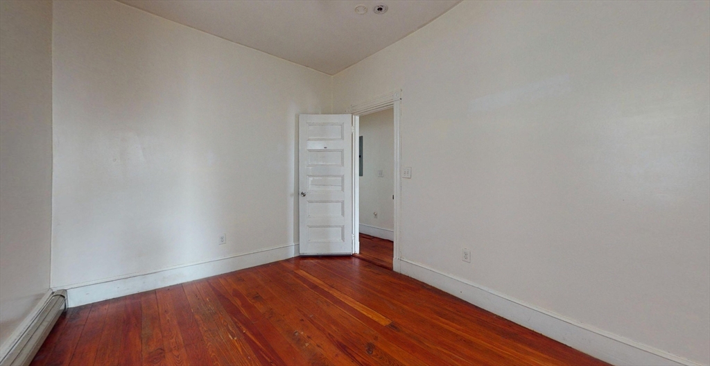 19 Newport Street, Unit 2 Boston, MA 02125 - Photo 2 of 13 a view of an empty room with wooden floor