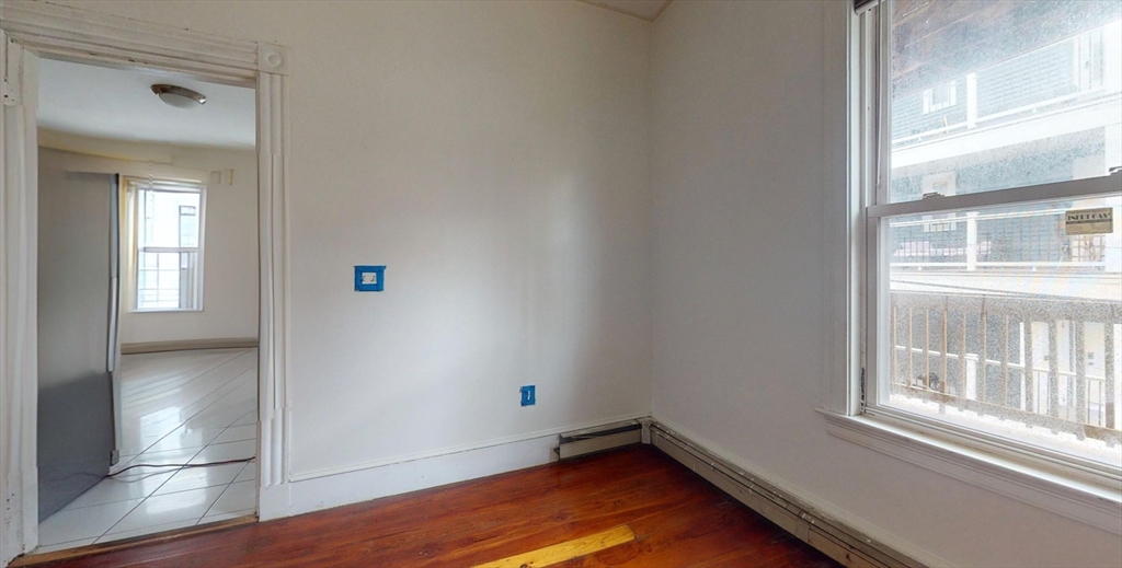 19 Newport Street, Unit 2 Boston, MA 02125 - Photo 3 of 13 a view of empty room with wooden floor and fan