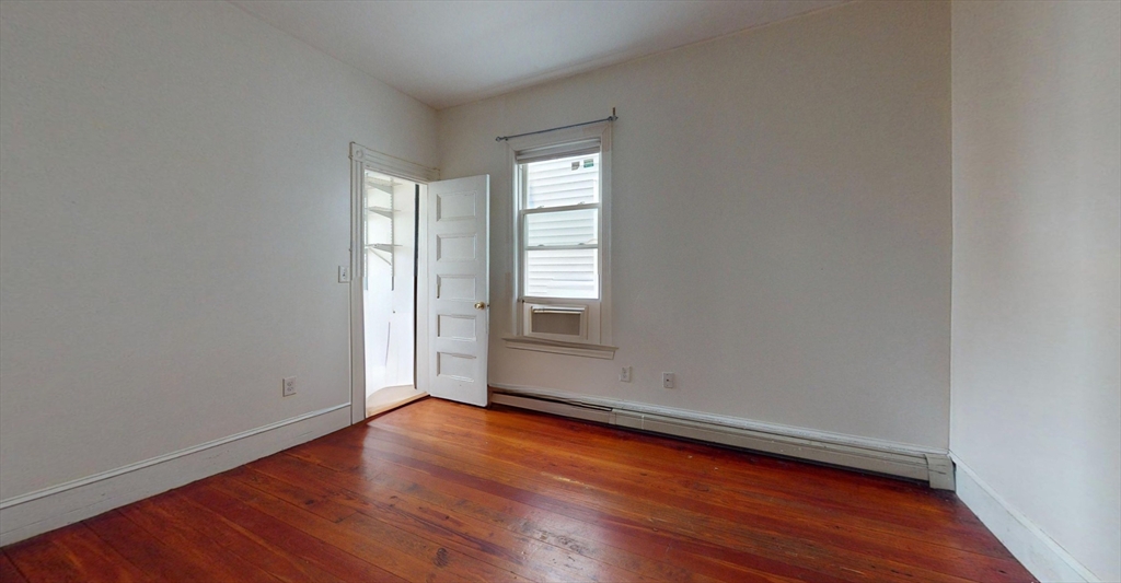 19 Newport Street, Unit 2 Boston, MA 02125 - Photo 4 of 13 an empty room with wooden floor and windows