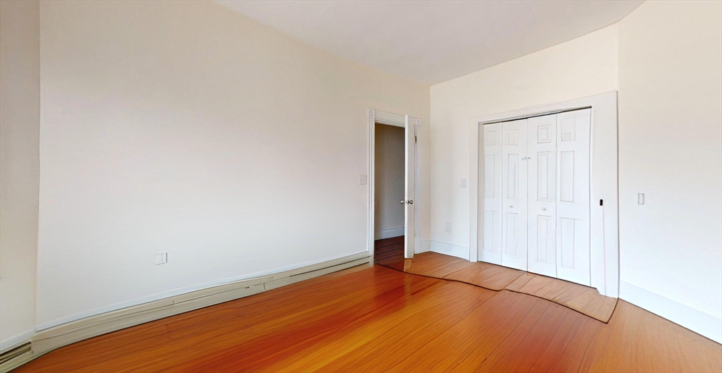 19 Newport Street, Unit 2 Boston, MA 02125 - Photo 10 of 13 a view of an empty room with wooden floor