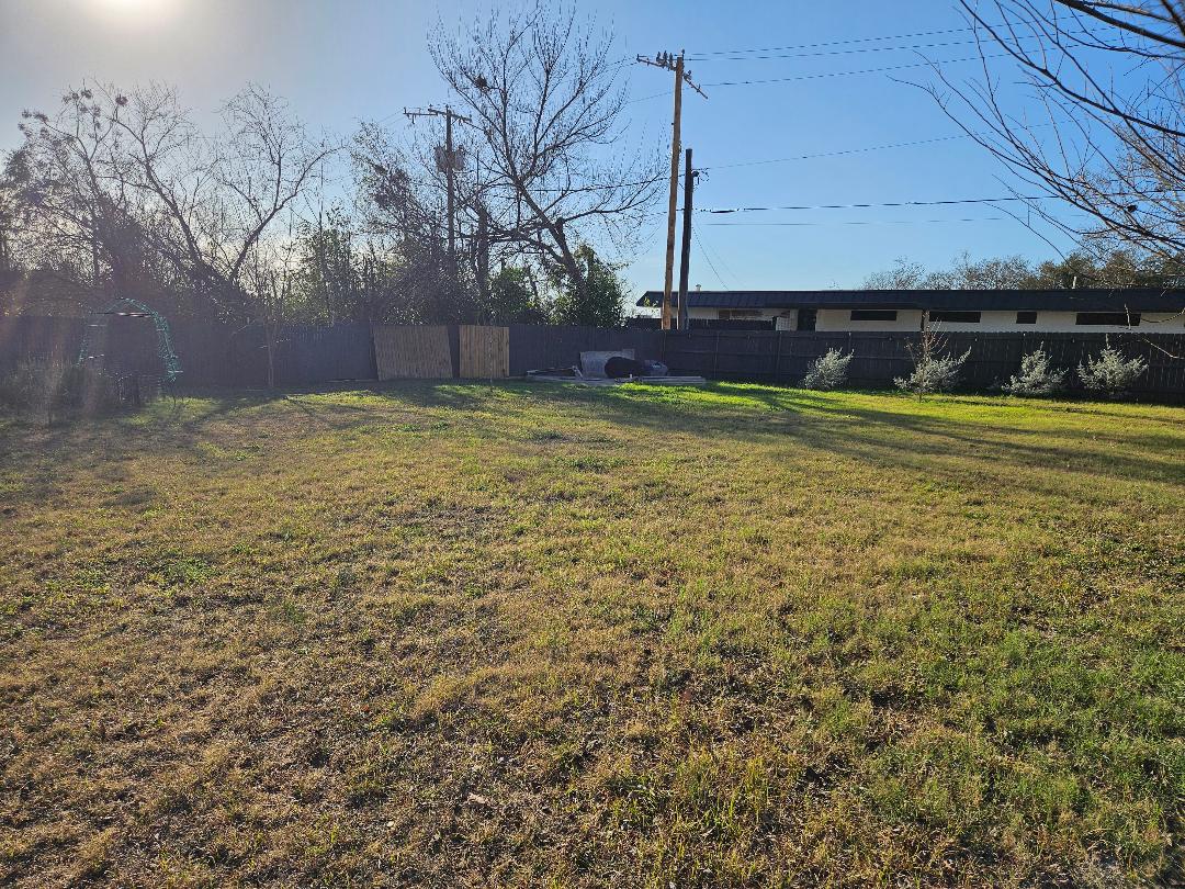 710 North Avenue C Elgin, TX 78621 - Photo 31 of 33 a view of an house with backyard space and garden