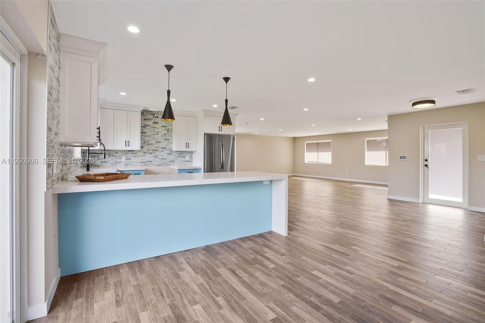 6701 Southwest 49th Terrace Miami, FL 33155 - Photo 11 of 35 a large kitchen with stainless steel appliances granite countertop a large counter top a sink and a wooden floors
