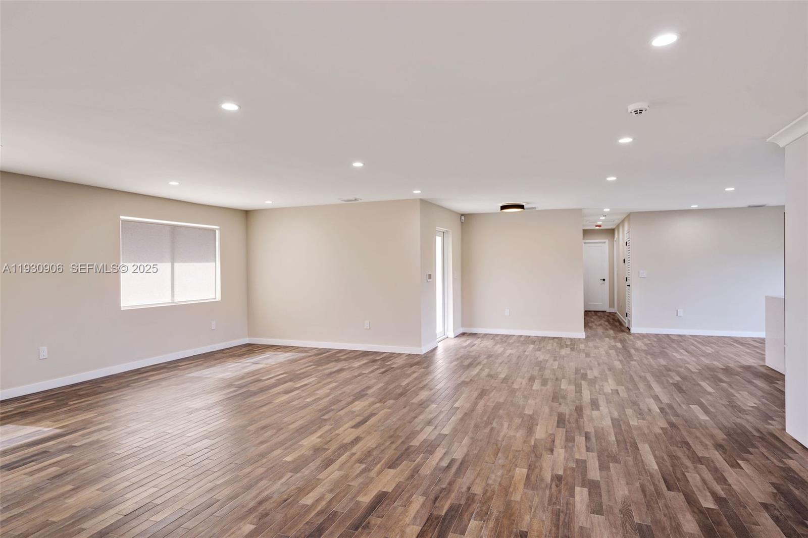 6701 Southwest 49th Terrace Miami, FL 33155 - Photo 16 of 35 a view of an empty room with wooden floor and a window