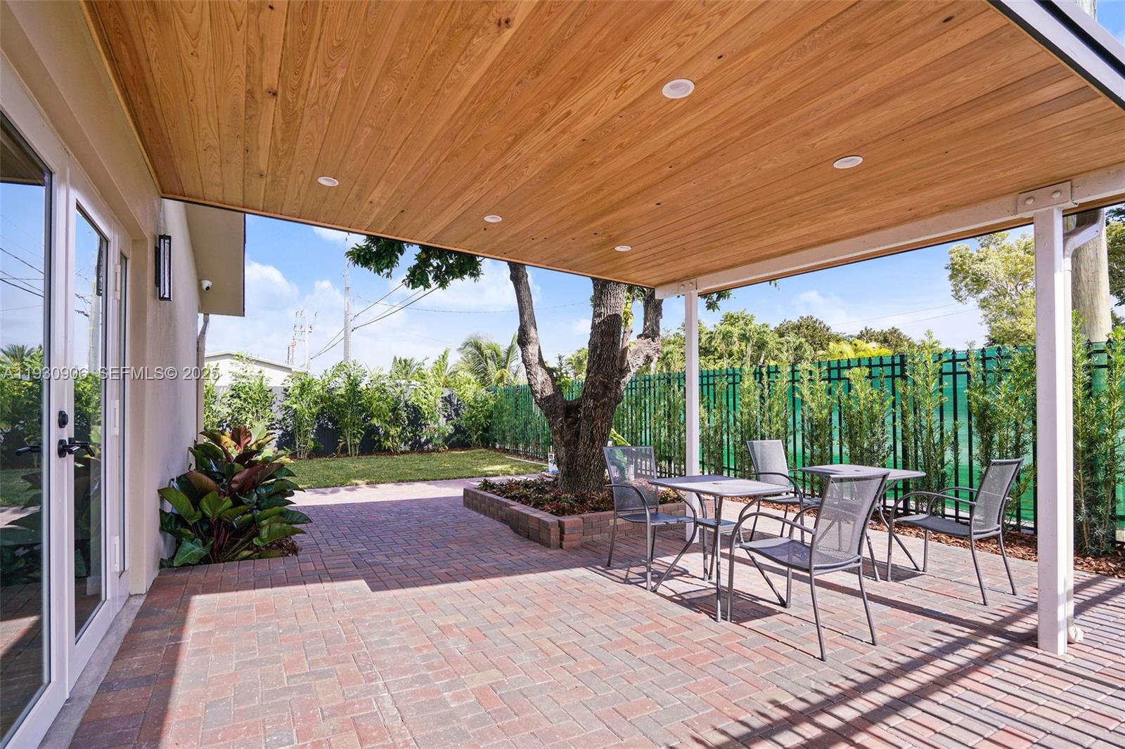 6701 Southwest 49th Terrace Miami, FL 33155 - Photo 19 of 35 a patio with yard glass top table and chairs