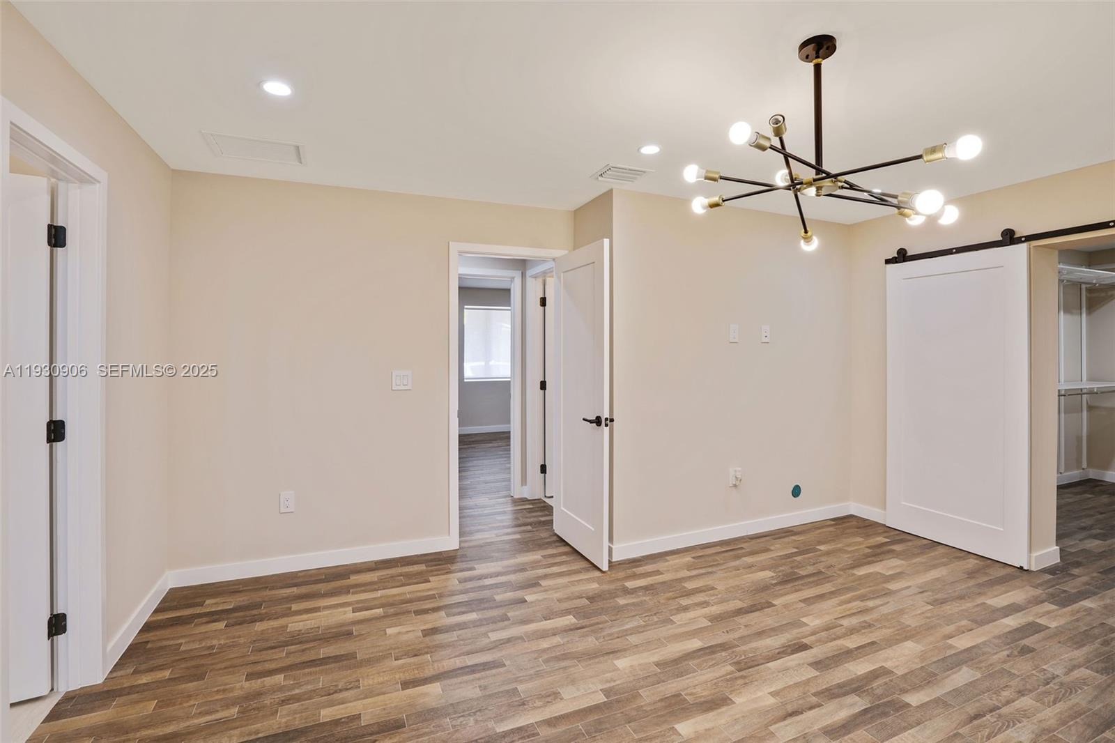6701 Southwest 49th Terrace Miami, FL 33155 - Photo 25 of 35 a view of empty room with wooden floor and ceiling fan