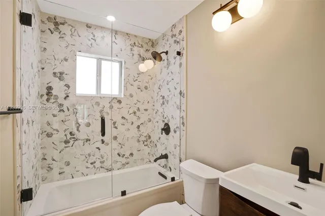a bathroom with a bathtub and shower