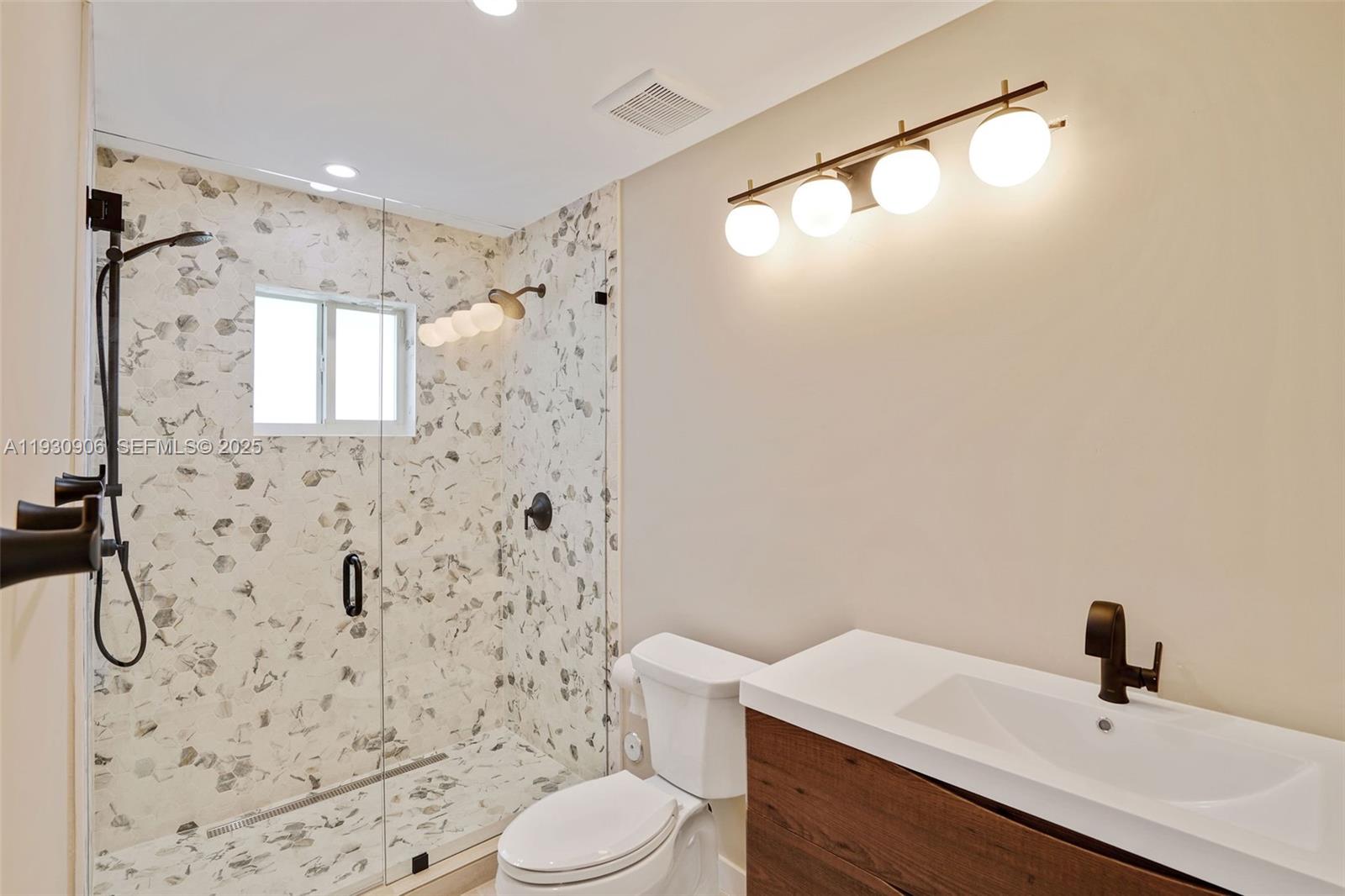 6701 Southwest 49th Terrace Miami, FL 33155 - Photo 27 of 35 a bathroom with a sink a toilet and shower