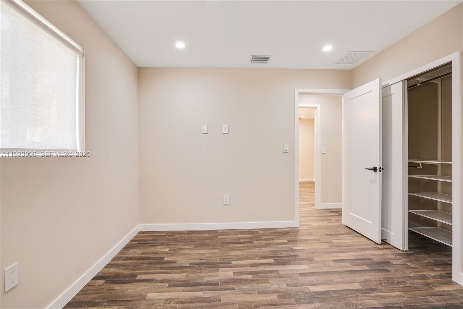 6701 Southwest 49th Terrace Miami, FL 33155 - Photo 29 of 35 a view of an empty room with wooden floor and closet