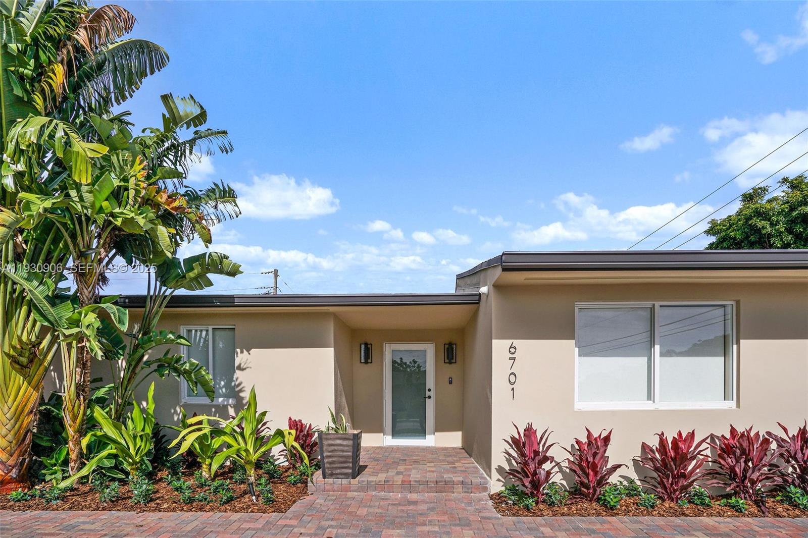 6701 Southwest 49th Terrace Miami, FL 33155 - Photo 6 of 35 a front view of a house with a lot of flowers