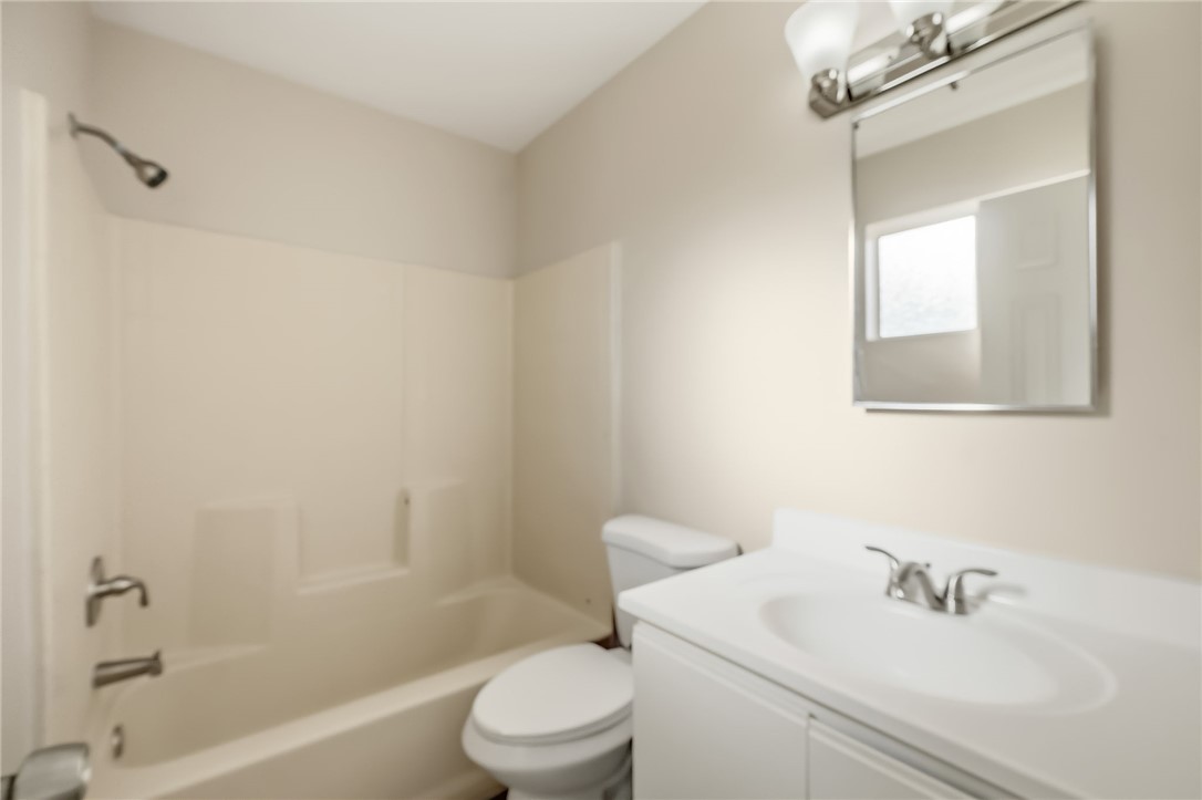 1720 Valencia Road Fort Mohave, AZ 86426 - Photo 28 of 32 Bathroom featuring a white vanity with integrated sink, chrome faucet, and mirrored medicine cabinet